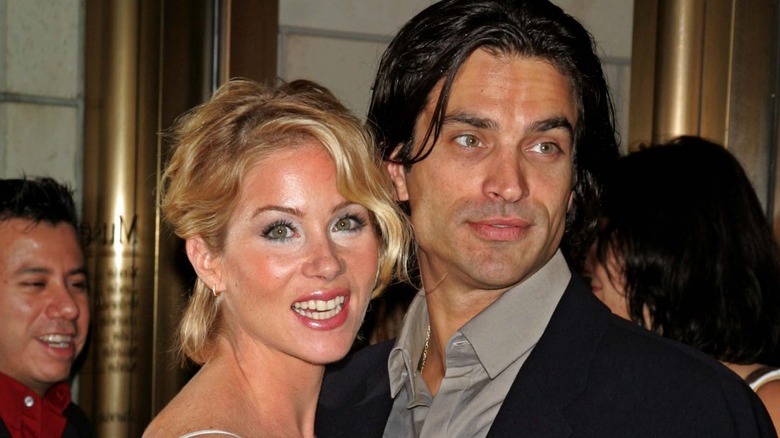 Christina Applegate smiling embracing Johnathon Schaech