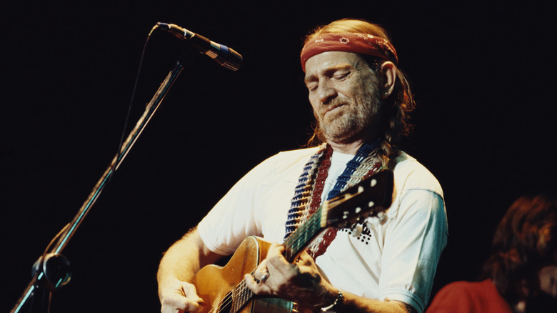 Willie Nelson playing guitar