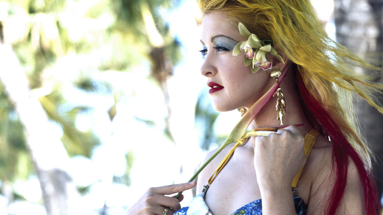 Cyndi Lauper looking away flowers in hair