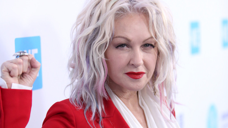 Cyndi Lauper raised fist red jacket