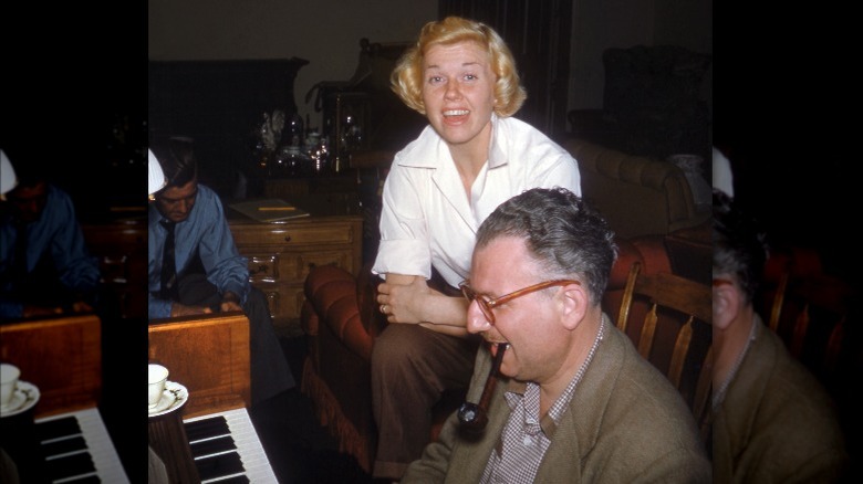 Doris Day sitting over George Weidler as he plays piano