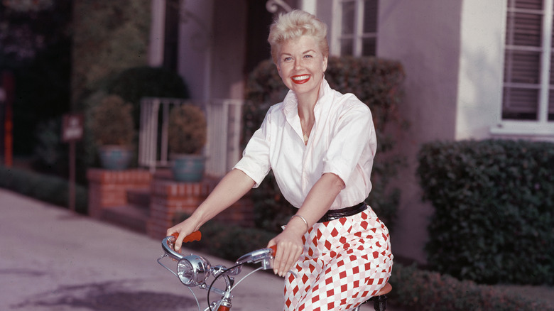 Doris Day riding a bike, smiling