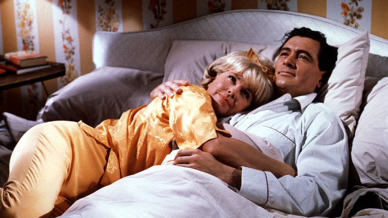 Doris Day and Rock Hudson embracing in bed