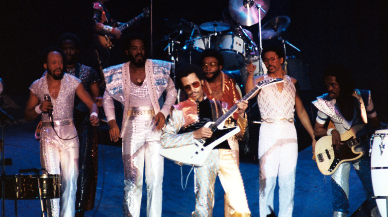 Earth, Wind & Fire on stage white costumes guitars