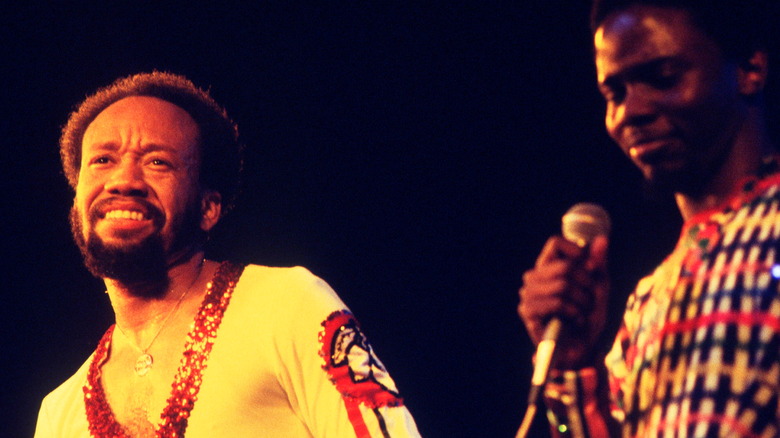 Philip Bailey and Maurice White onstage mic smiling