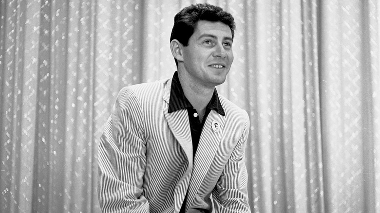 Eddie Fisher in front of a curtain