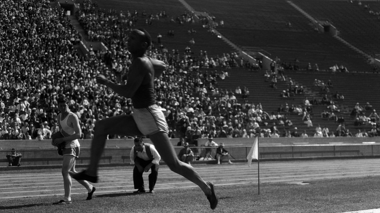 Jesse Owens, competing in a broad jump, 1930s