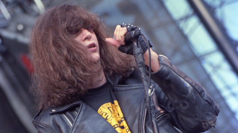 Joey Ramone performing on stage leather jacket