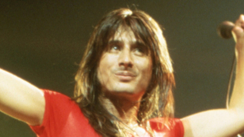 Steve Perry boasting on stage Journey
