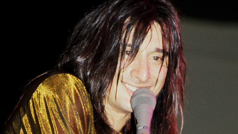 Steve Perry smiling singing with Journey