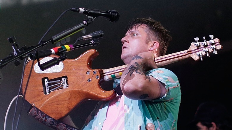 Isaac Brock holding a guitar on stage