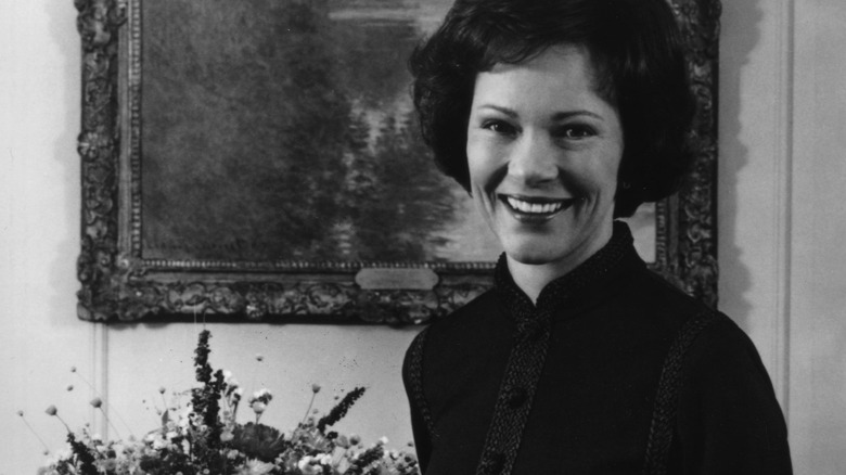 Rosalynn Carter in front of a painting