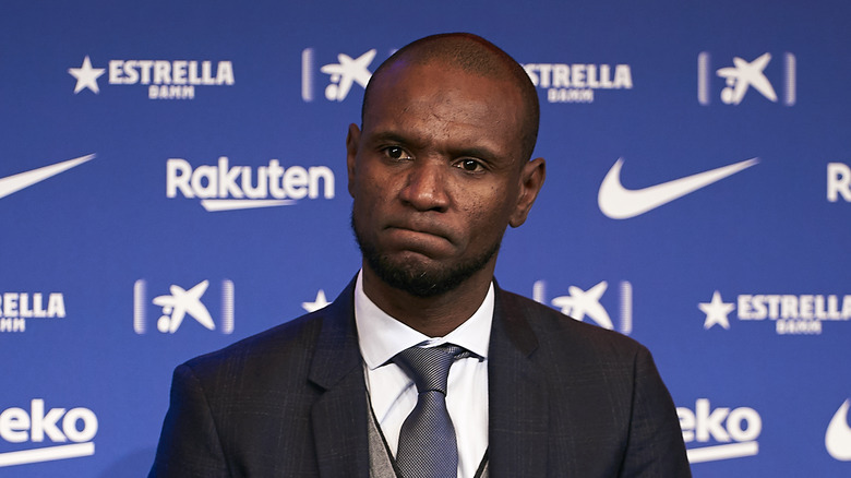 Eric Abidal wearing a suit and tie