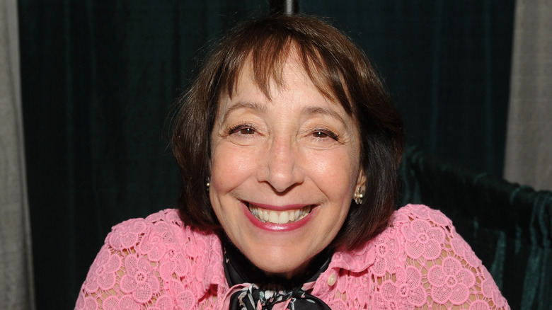 Didi Conn smiles pink shirt