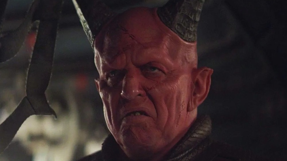 Clancy Brown red horns alien makeup scowling