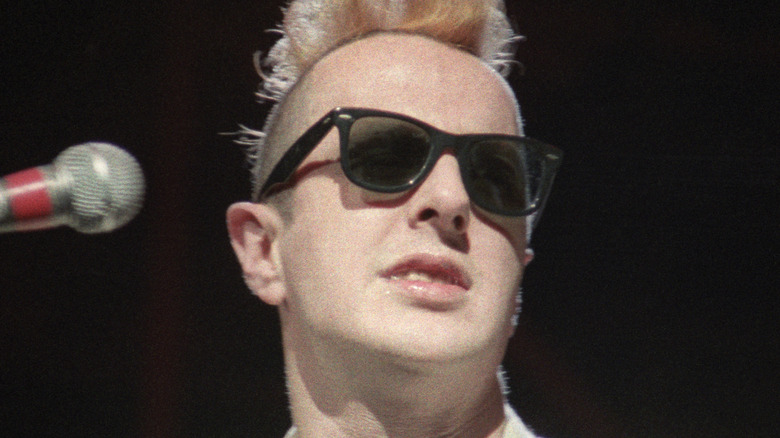 Joe Strummer The Clash performing white suit sunglasses