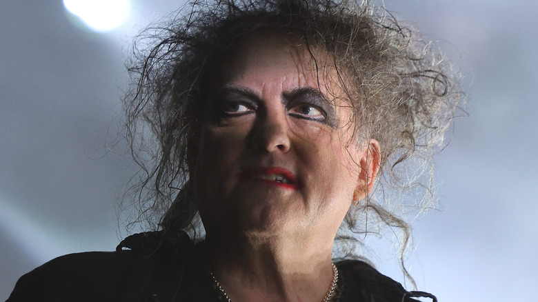 Robert Smith on stage in shadows