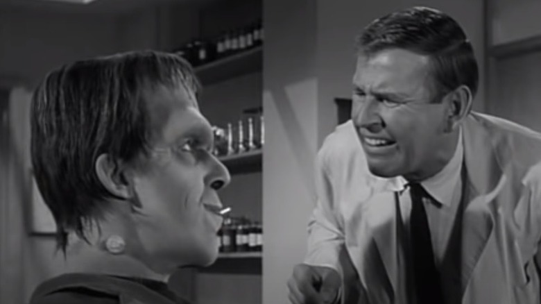 Paul Lynde as Dr. Dudley examines Herman Munster