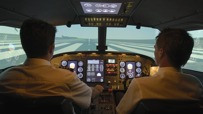 Pilots sitting in cockpit