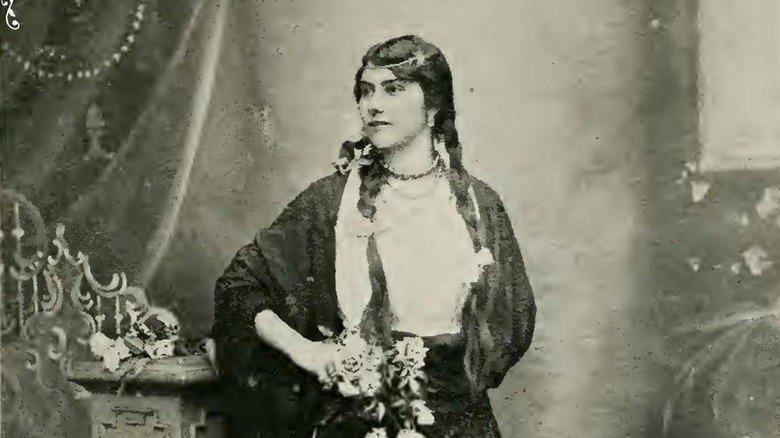 eliza lynch portrait holding flowers dress