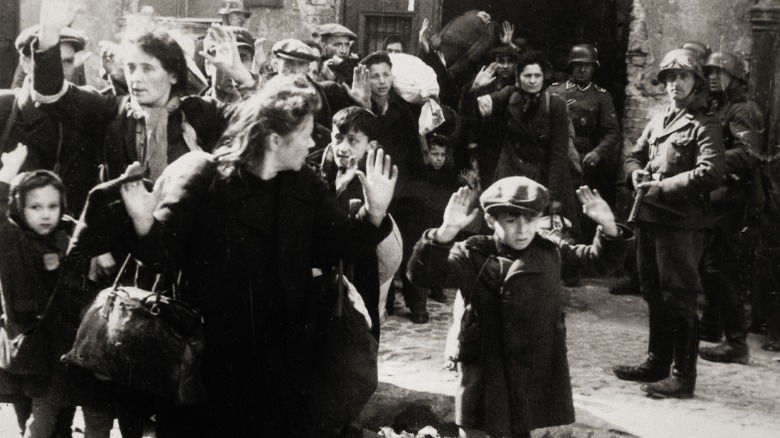 Jewish women and children raising hands