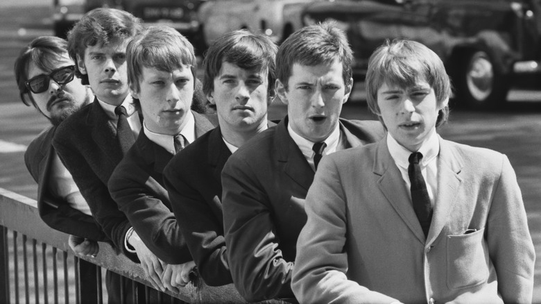 The Yardbirds lined up against railing