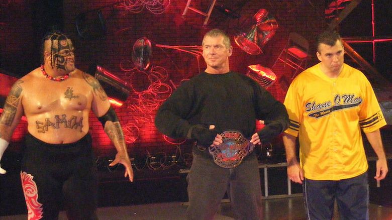 Umaga accompanies Vince and Shane McMahon