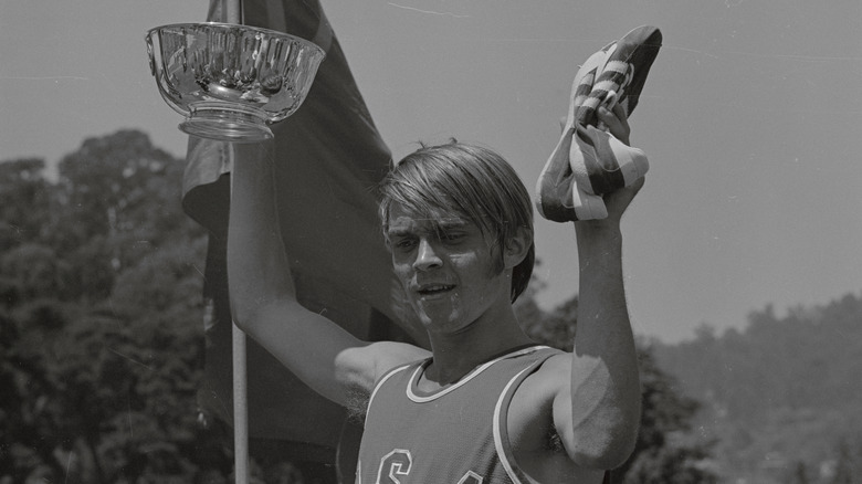 Steve Prefontaine holding bowl and shoes