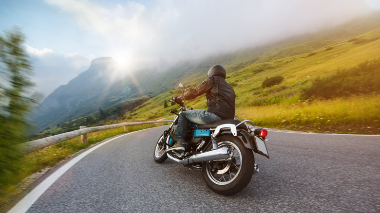 man riding motorcycle near mountain