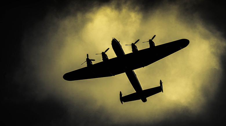 Lancaster bomber flies in dark sky