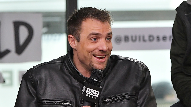 Jake Anderson sat interview black leather jacket