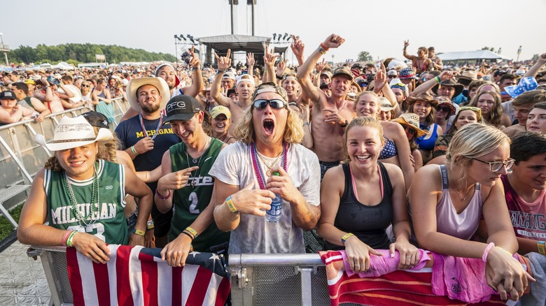 Crowd of fans smiling and waving