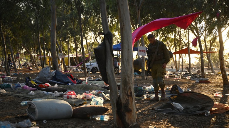 IDF soldier standing over destroyed campground