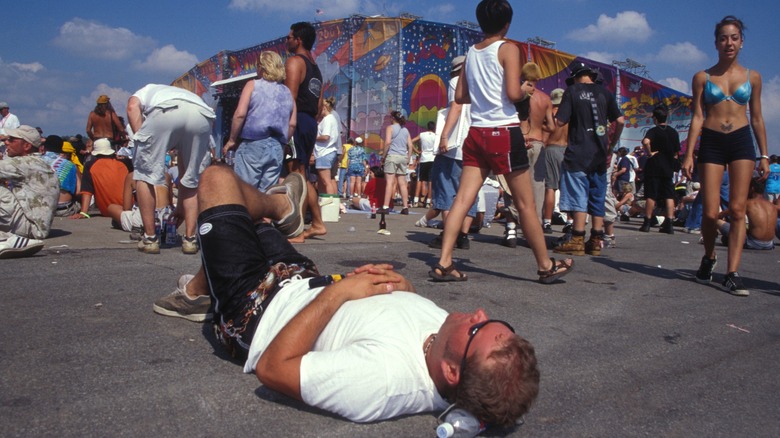 Man laying on concrete at festival