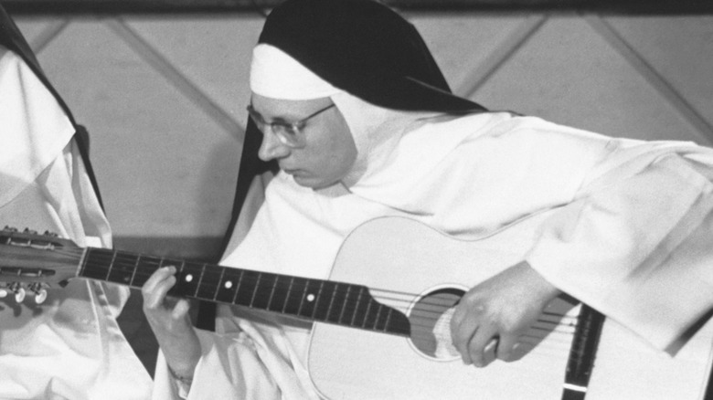 The Singing Nun playing guitar
