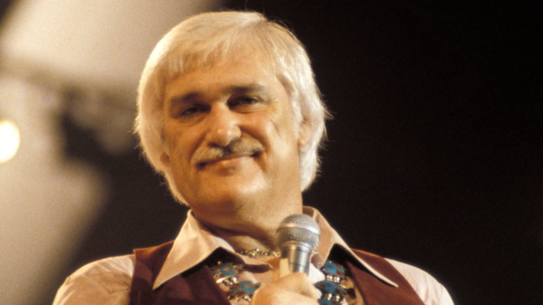 charlie rich smirking on stage in the 70s