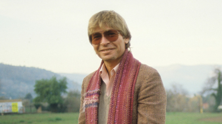 john denver wearing giant sunglasses in a field