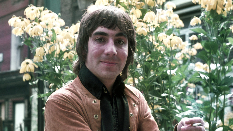 keith moon grinning in front of flowers