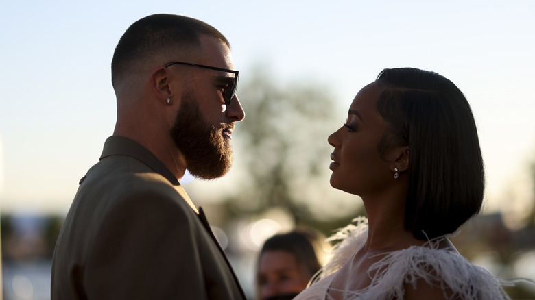 Travis Kelce and Kayla Nicole face each other outside