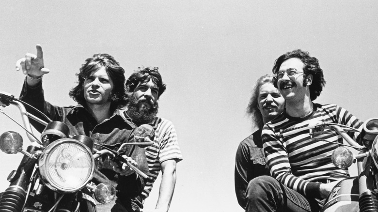 Creedence Clearwater Revival riding two motorcycles