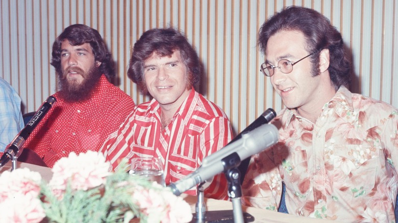 Creedence Clearwater Revival sitting together with mics