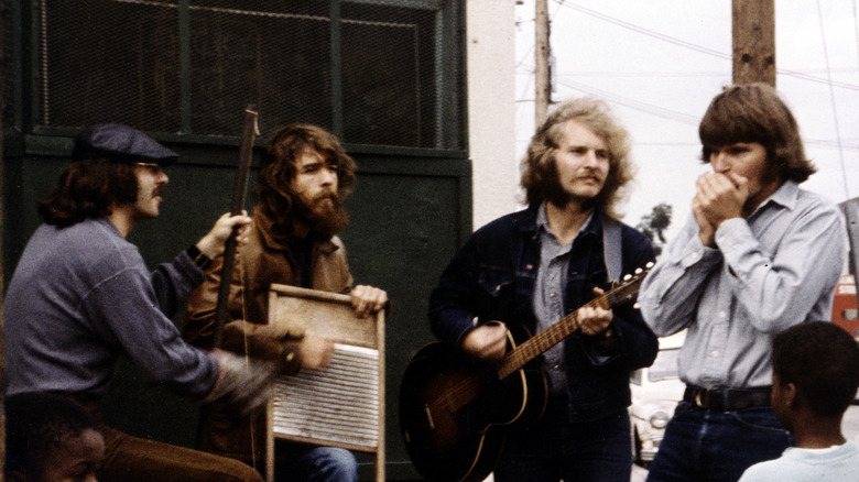 Creedence Clearwater Revival performing on a street