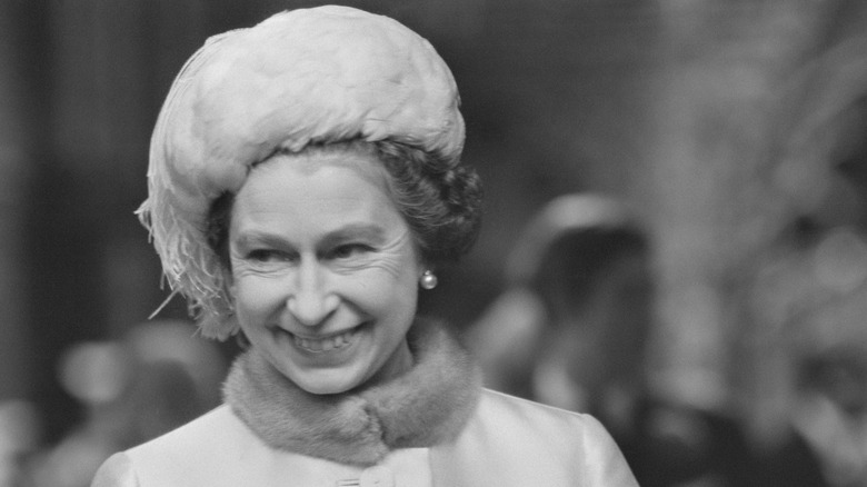 Queen Elizabeth II smiling to side