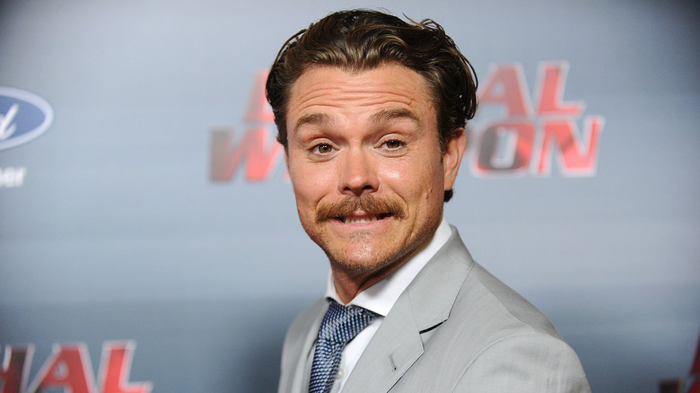 Clayne Crawford grinning moustache grey suit event