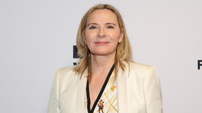 Kim Cattrall smiling white suit event