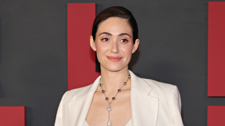 Emmy Rossum smiling white suit event