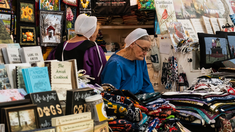 senior amish woman at market stall