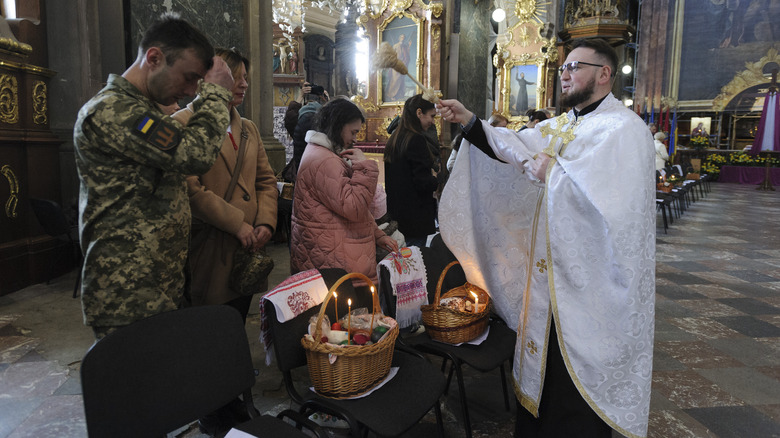 Ukrainian Catholic priest blessing soldiers Easter baskets