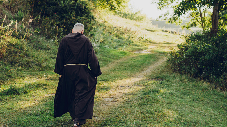 Catholic monk walking path woods