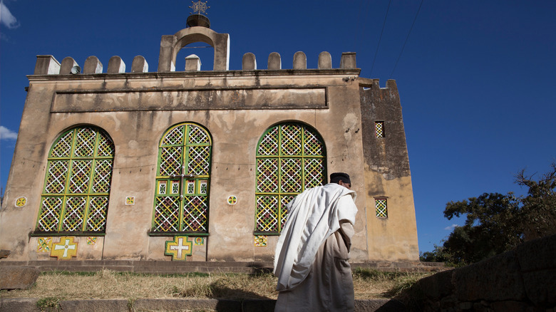 priest at st mary of zion in aksum, ethiopia